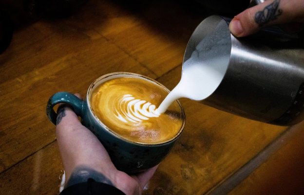 A latte coffee having milk added to it.