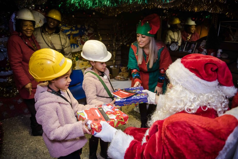 Santa Underground handing out gifts