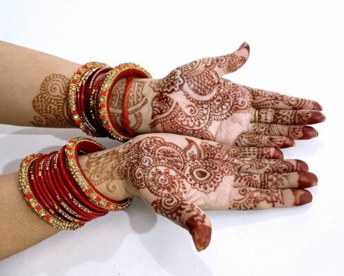 A pair of hand with henna designs on them