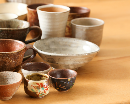 Various ceramic cups and bowls displayed on a table.